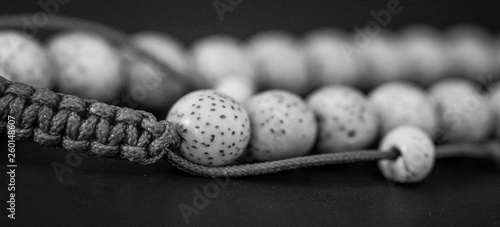 Konstfotografi Black and white, detailed close-up of Lotus Seeds strung on mala or wristlet
