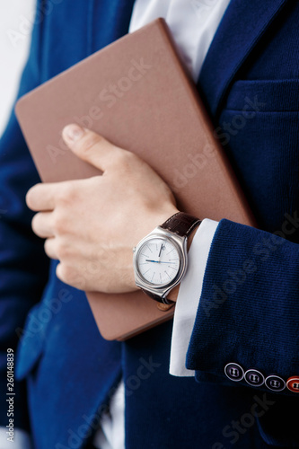 hand of businessman with clock closeup