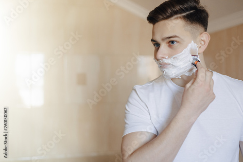 morning hygiene, man shaves with foam