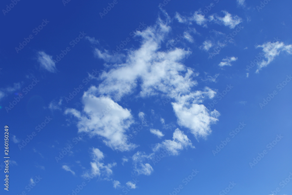 Fluffy white clouds on the blue color sky background