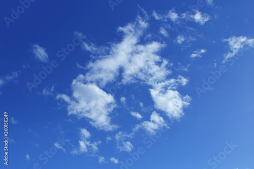 Fluffy white clouds on the blue color sky background