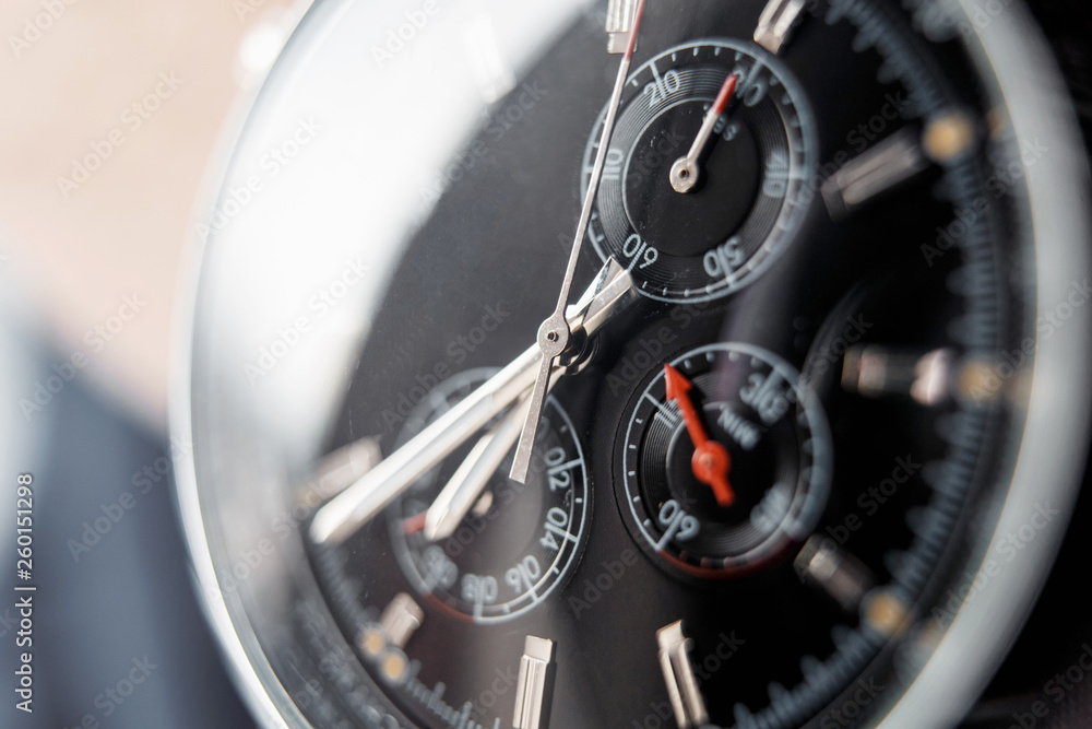 Close up front view of a modern wrist watch on the table. Soft focus. Close up front view of a modern wrist watch on the table. Soft focus.