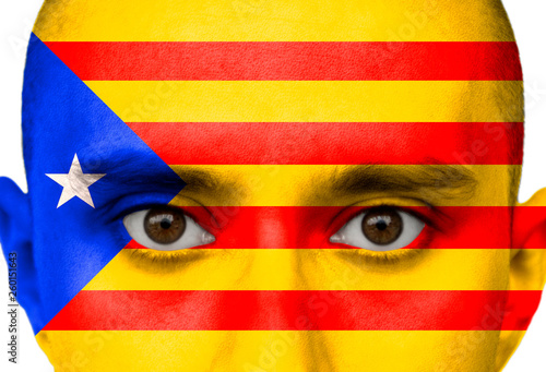 National flag Spain, Catalonia colored depicted in paint on a man's face close-up, isolated on a white background