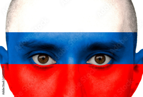 National flag Russia colored depicted in paint on a man's face close-up, isolated on a white background