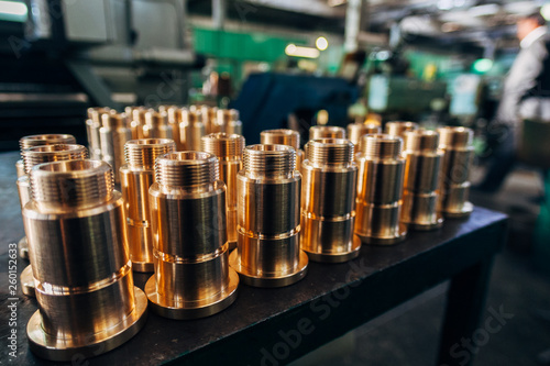 New brass threaded bushings on table in factory photo