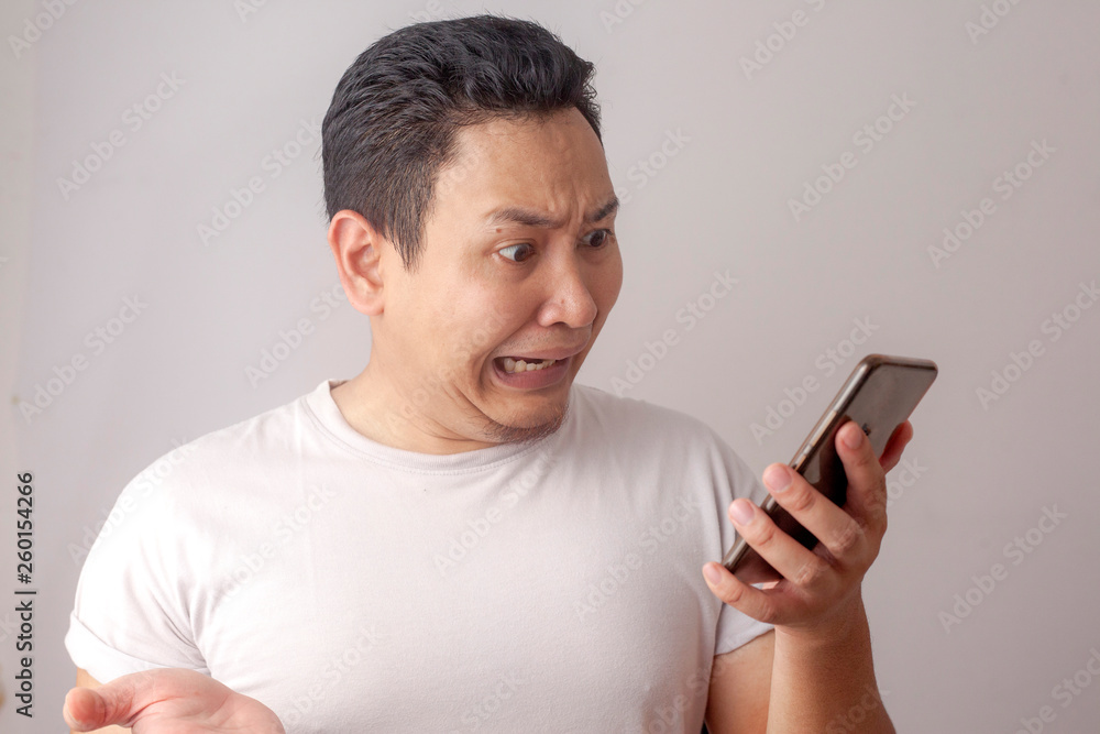 Young Man Texting Reading Chatting on His Phone Sad Crying Young Man Texting Reading Chatting on His Phone Sad Crying