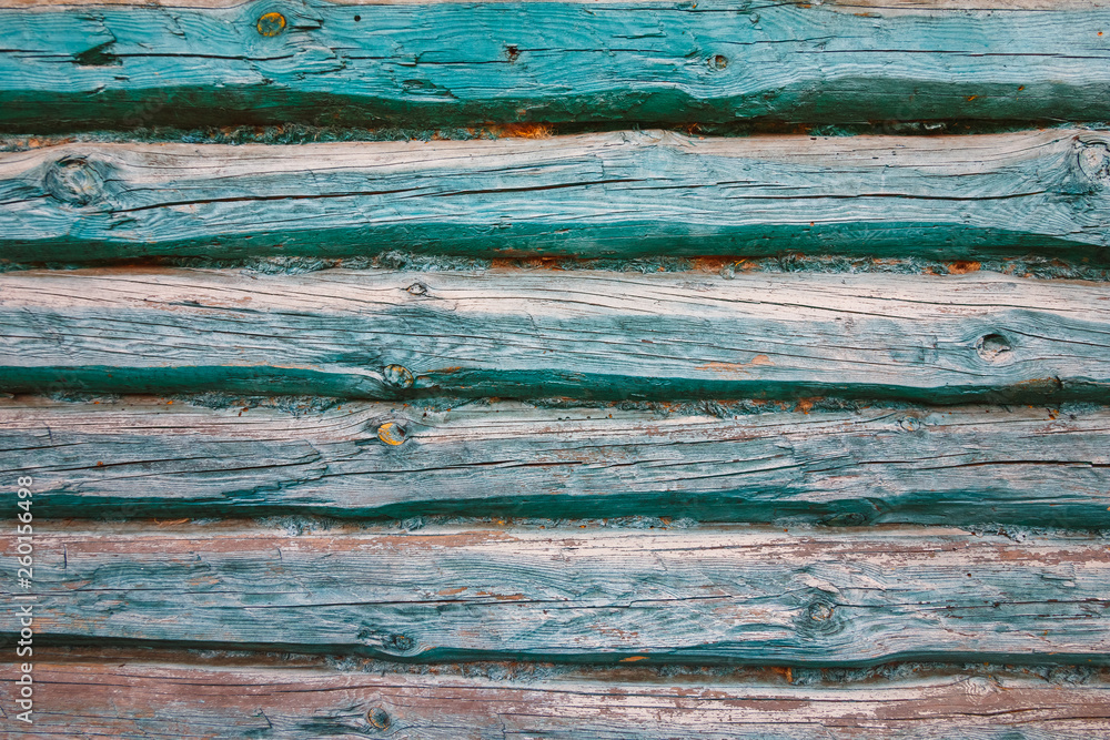 The texture of the turquoise wall of the logs of the old house The texture of the turquoise wall of the logs of the old house