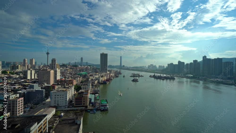 Pan from Pearl River delta under ar bright blue cloudscape to the Macau skyline, Macau,China Pan from Pearl River delta under ar bright blue cloudscape to the Macau skyline, Macau,China