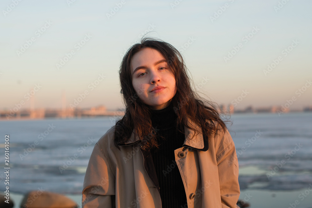 Portrait of a beautiful girl in an autumn raincoat, outdoors. Portrait of a beautiful girl in an autumn raincoat, outdoors.