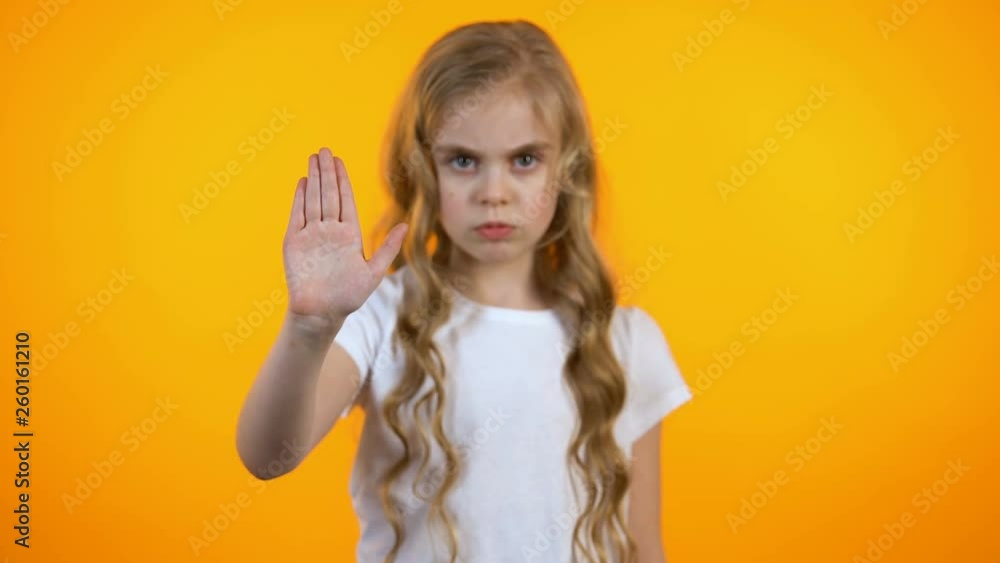 Serious girl shaking head and showing stop gesture, rejecting family violence Serious girl shaking head and showing stop gesture, rejecting family violence