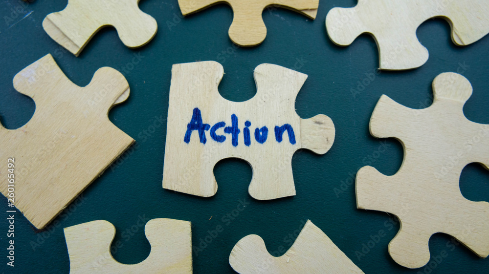 Wooden jigsaw puzzle with text Action Wooden jigsaw puzzle with text Action