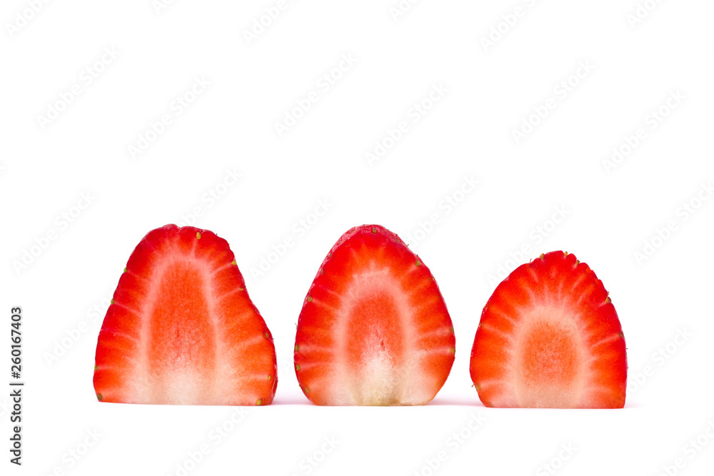 Plate of sliced strawberries isolated on white background. Strawberry berry on a white background. Neatly arranged slices of red strawberry on a white background. Plate of sliced strawberries isolated on white background. Strawberry berry on a white background. Neatly arranged slices of red strawberry on a white background.
