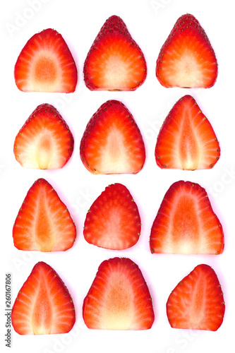 Plate of sliced strawberries isolated on white background. Strawberry berry on a white background. Neatly arranged slices of red strawberry on a white background.