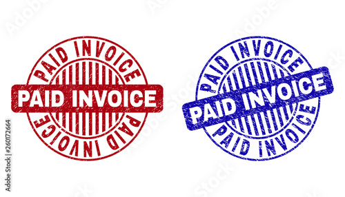 Grunge PAID INVOICE round stamp seals isolated on a white background. Round seals with grunge texture in red and blue colors.