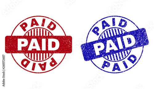 Grunge PAID round stamp seals isolated on a white background. Round seals with grunge texture in red and blue colors. Vector rubber watermark of PAID label inside circle form with stripes.