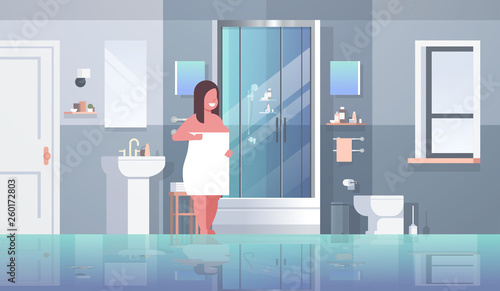 fat obese woman wrapped with white towel overweight girl standing in bathroom after shower obesity concept modern apartment interior horizontal full length