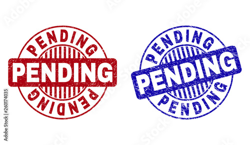 Grunge PENDING round stamp seals isolated on a white background. Round seals with grunge texture in red and blue colors. Vector rubber imitation of PENDING title inside circle form with stripes.