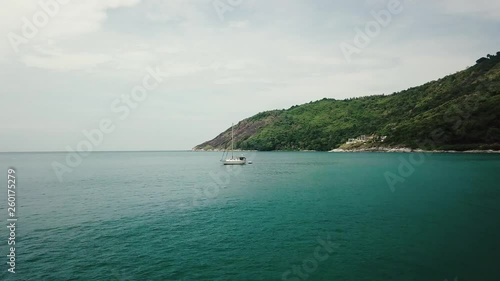 AERIAL: Flying over the ocean to sail boat, Thailand photo