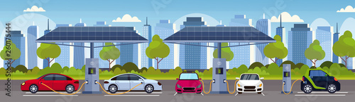 electric cars charging on electrical charge station with solar panels renewable eco friendly transport environment care concept flat modern cityscape background horizontal