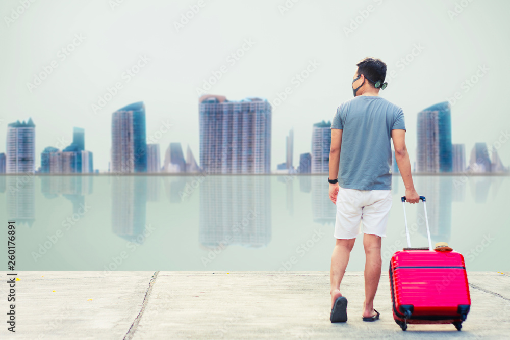 Man holding Red luggage with passport on blurred city background for activity lifestyle outdoors freedom or travel tourism andinspiration backpacker alone tourist image Man holding Red luggage with passport on blurred city background for activity lifestyle outdoors freedom or travel tourism andinspiration backpacker alone tourist image