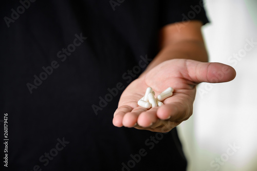man hand holding frug medicine bottle on Herbal supplement pill eating healthy