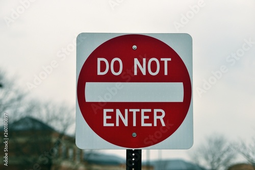 A large sign prohibiting entry to a one-way street warns motorists of the restriction.