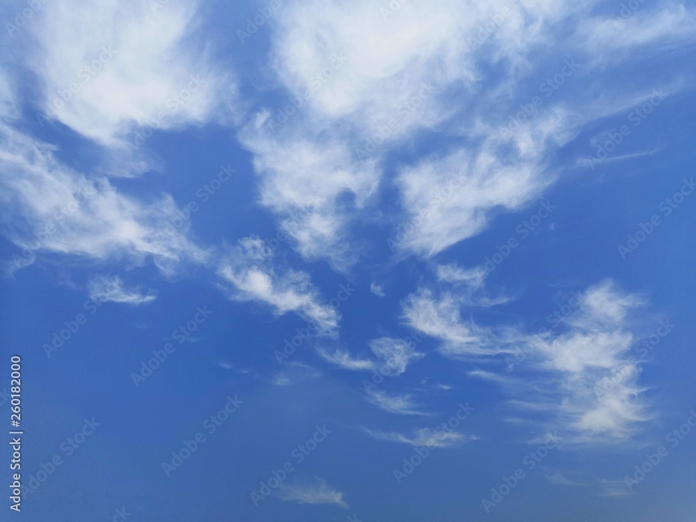 blue sky with white, soft clouds.The sky is clear.