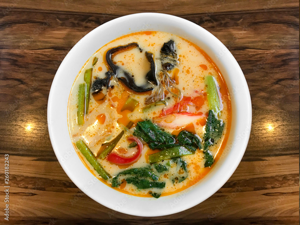 ShangHai hot sauce noodles in red soup bowl on wood table background. ShangHai hot sauce noodles in red soup bowl on wood table background.