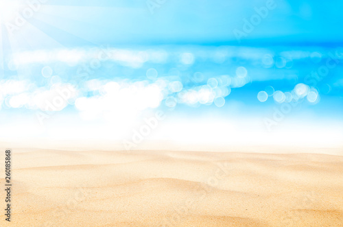 Blur tropical beach with bokeh sun light wave abstract background. © tonktiti