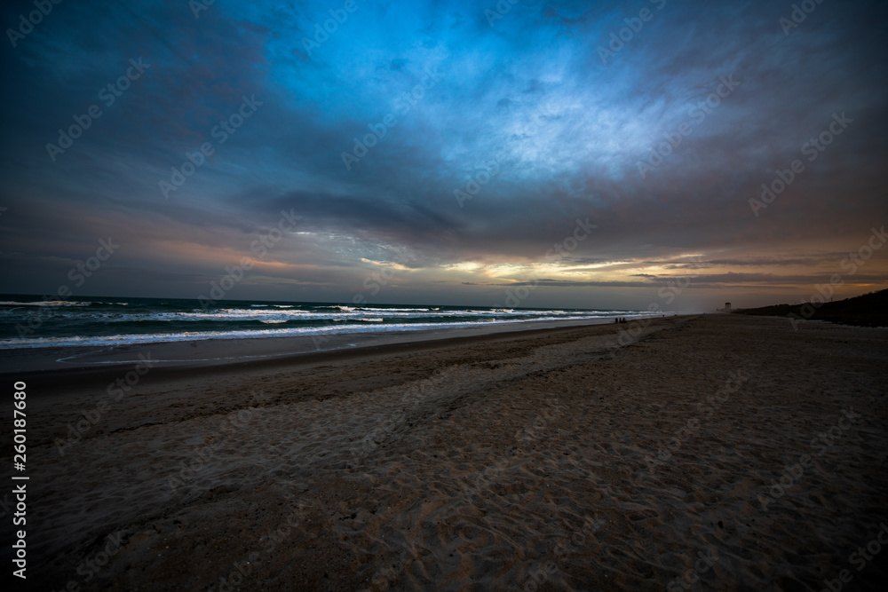 Colorful beach sunrise with a vibrant sky line 