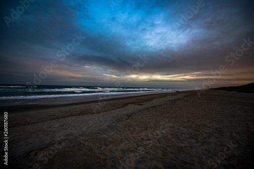 Colorful beach sunrise with a vibrant sky line 