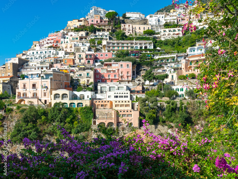 View of the colorful houses of Positano framed with flowers