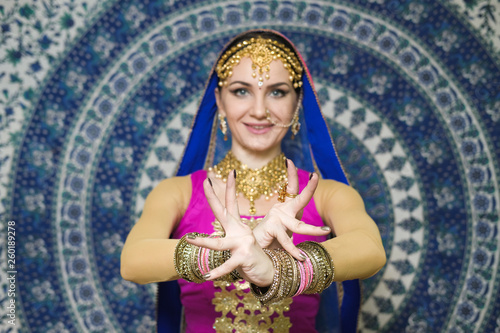 Portrait of a female model in ethnic indian costume with jewellery and traditional makeup.