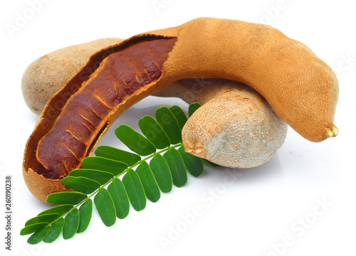 fresh tamarind fruits and leaves isolated on white