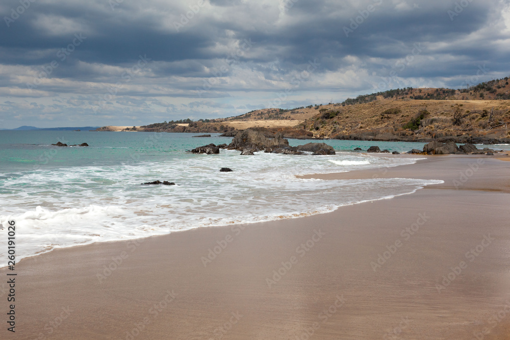 A storm is approaching and the beautiful secluded beach is seeing the last fading patches of sunlight. A storm is approaching and the beautiful secluded beach is seeing the last fading patches of sunlight.