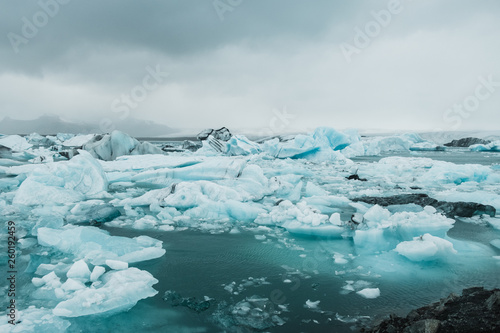 Glacier water covered in ice floes in Nordic landscape in Iceland