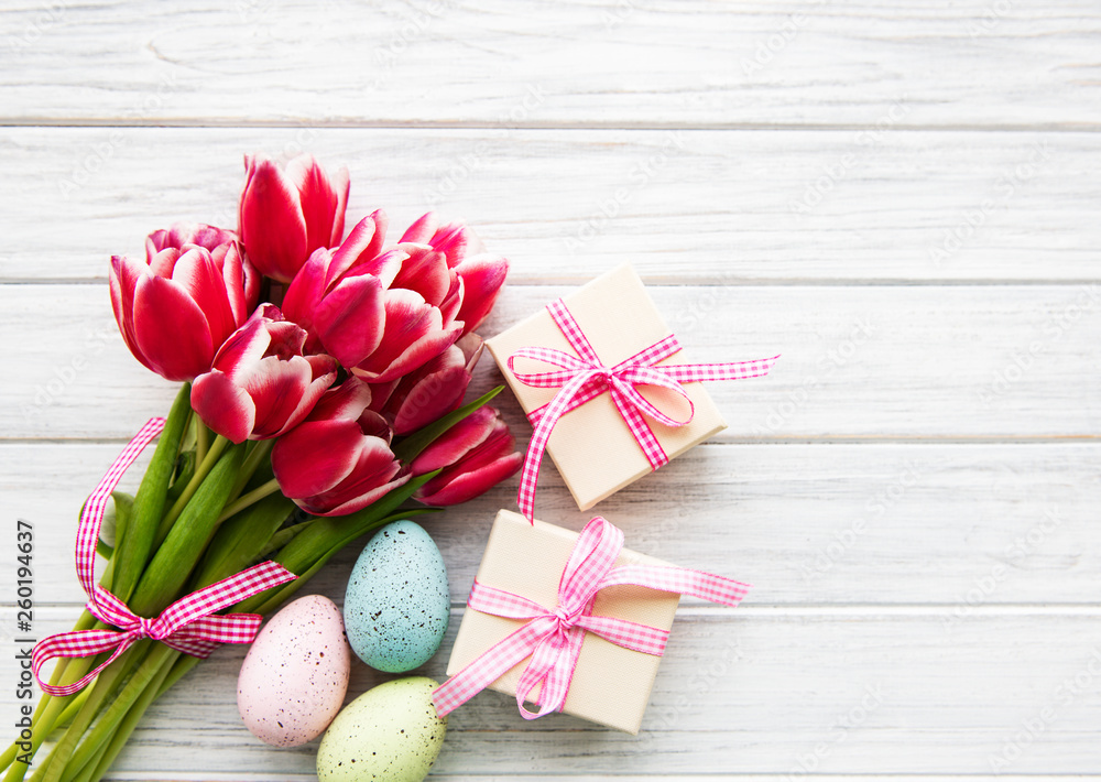Gift boxes, easter eggs and tulips bouquet