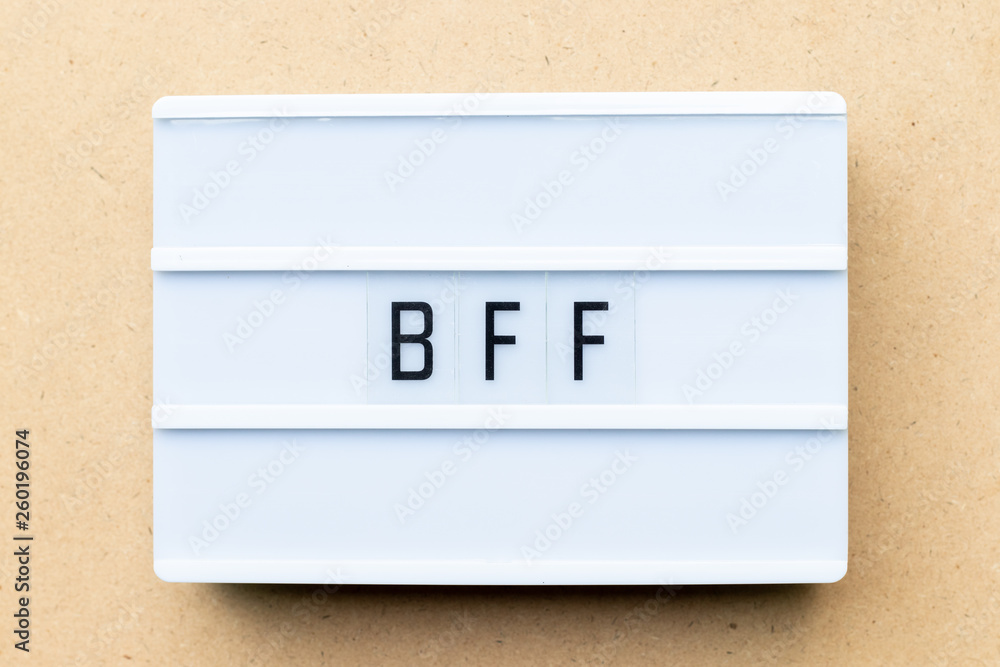 White lightbox with word BFF (Abbreviation of best friend forever) on wood background White lightbox with word BFF (Abbreviation of best friend forever) on wood background