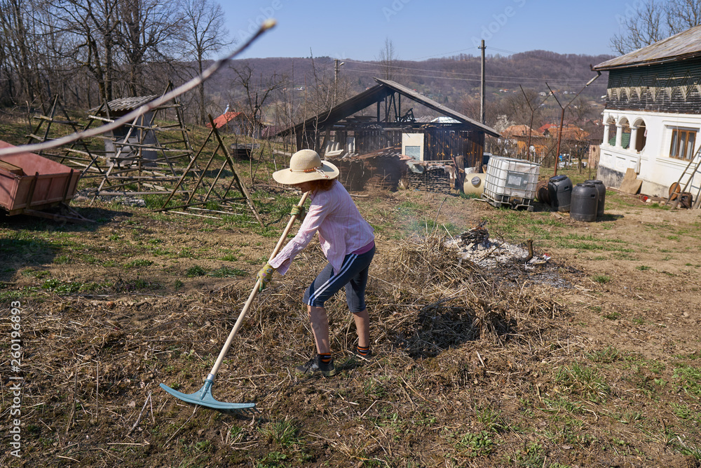 Woman farmer burning cut branches and leaves Woman farmer burning cut branches and leaves