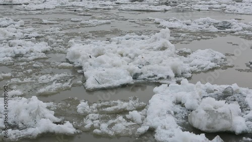 Cracked ice floes floating on the Siberian river, Altay