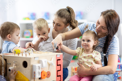 Kids play with educational toy in nursery photo