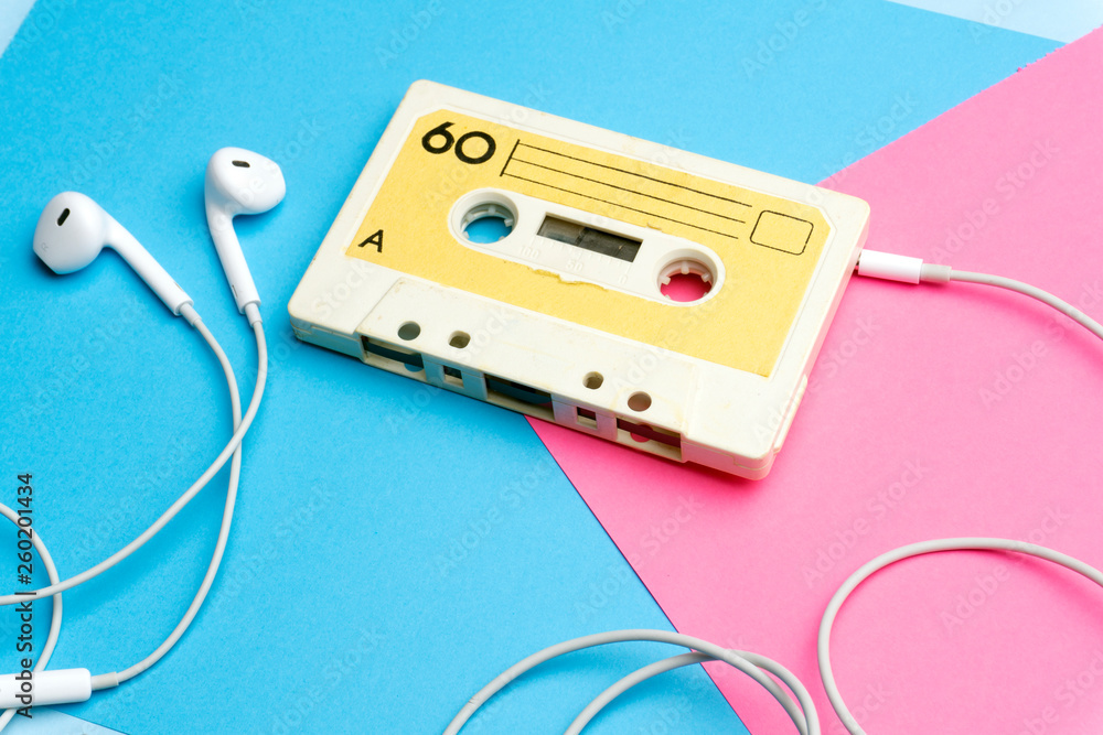 Retro old school 80-s or 90-s concept. Audio cassette on a bright blue-pink background Retro old school 80-s or 90-s concept. Audio cassette on a bright blue-pink background