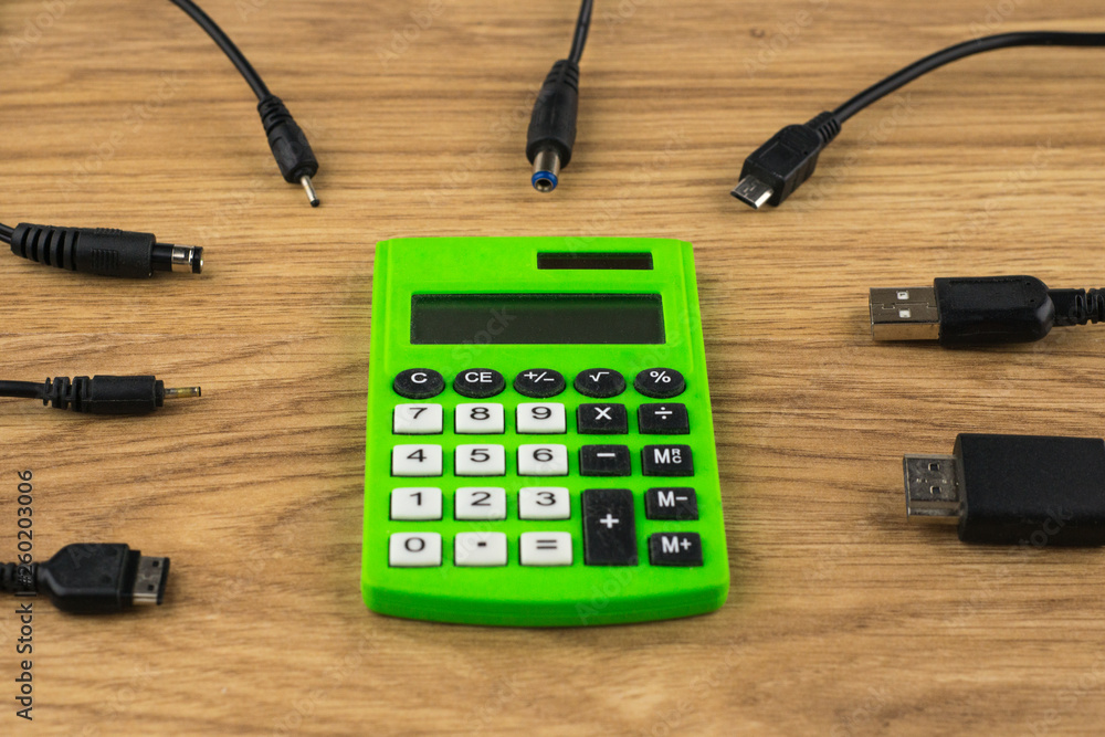 technology generation gap: old dusty calculator and lots of plugs that can't connect to it, with perspective