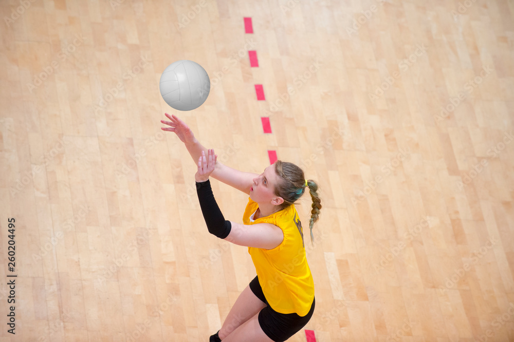 Fototapeta premium Upper View of Female Volleyball Player at Service