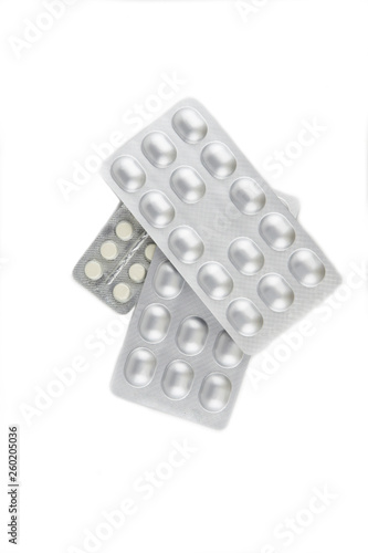 expensive drugs for chemotherapy: some plates are tablets silver in color, scattered on the surface, isolated on white