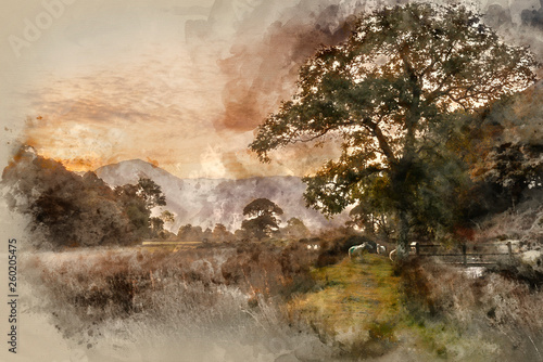 Watercolour painting of Beautiful foggy misty Autumn sunrise over countryside surrounding Crummock Water in Lake District in England © veneratio