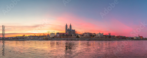 Panoramic view of bloody sunset in front of cathedral in Magdeburg, Germany, Spring, red cloudy sky