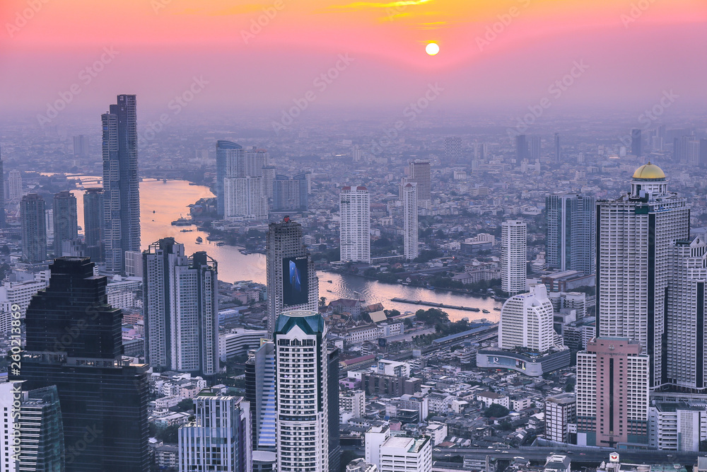 View of Bangkok skyline and skyscraper Panorama over Chao Phraya River Bangkok Thailand at sunset.