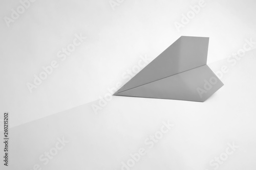 paper airplane on pastel background. Minimal flat lay school concept.