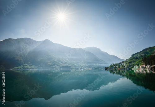 The sun is up creating blue and mystic scenery over Odda town located on the Hardangerfjord